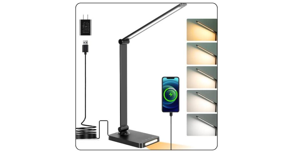 Black LED desk lamp with warm yellow glow illuminating open textbook on college dorm desk at night with laptop nearby